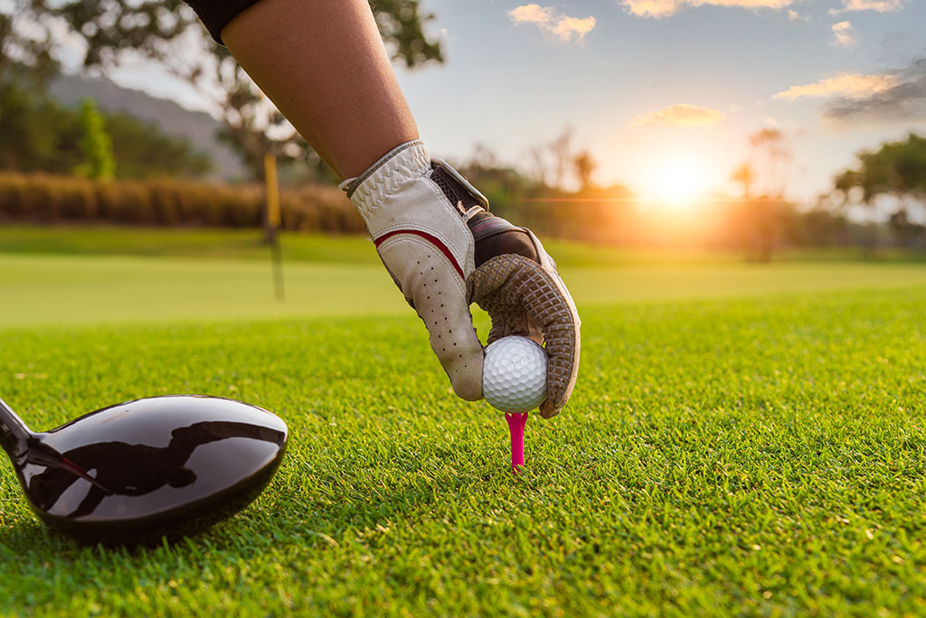 Golfer putting the ball onto the tee