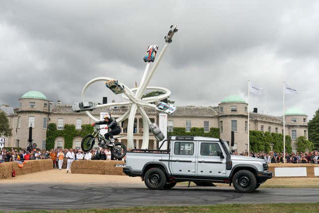 Trials rider Dougie Lampkin does a stunt out of the back of the Ineos Quartermaster pickup