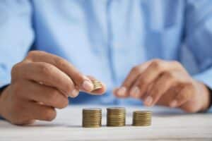 man's hands stacking coins