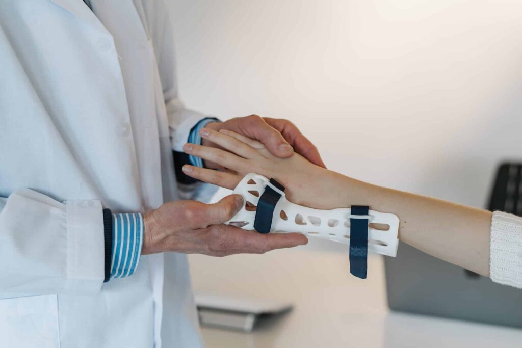 doctor putting a cast on patient's wrist