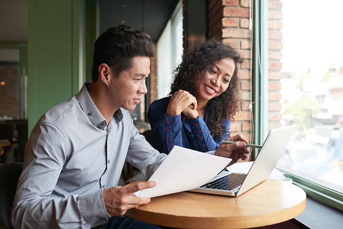 Husband and wife looking at the terms of their insurance policy