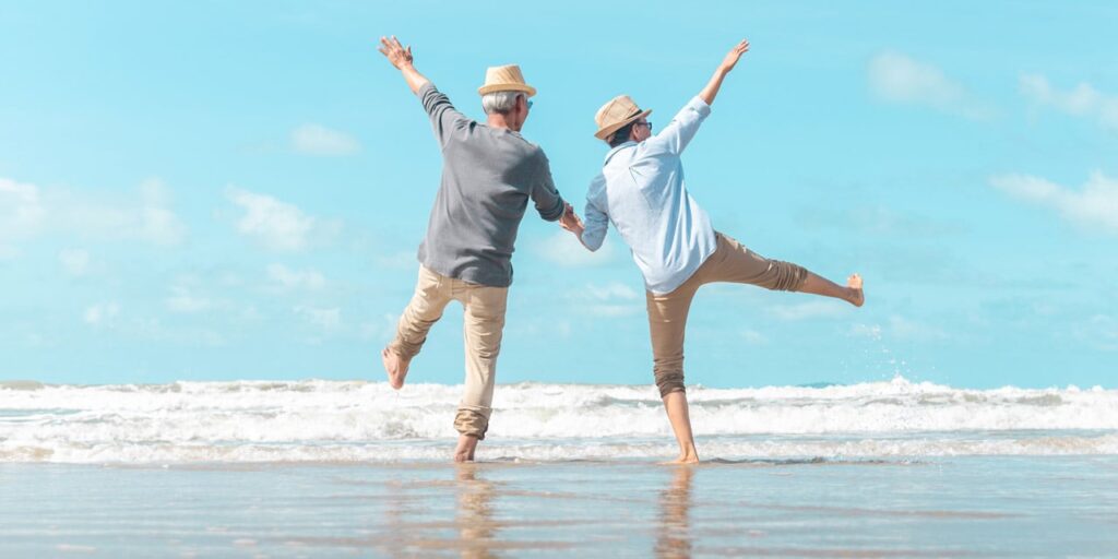 Senior couple frolicking at the beach