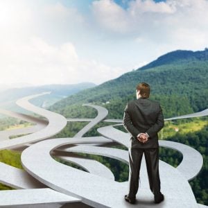 Businessman looking at winding roads