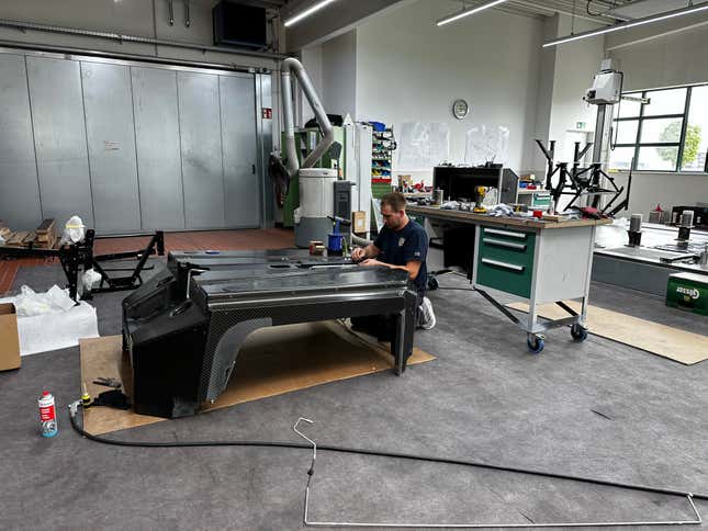The chassis department at Ruf Automobile with one man assembling a carbon tub