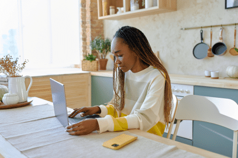 beautiful woman is sitting at home in a comfortable environment at her computer