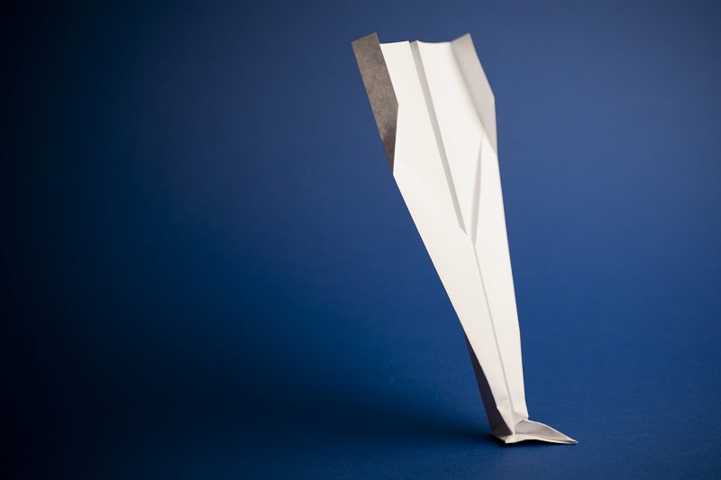 Paper airplane on blue background