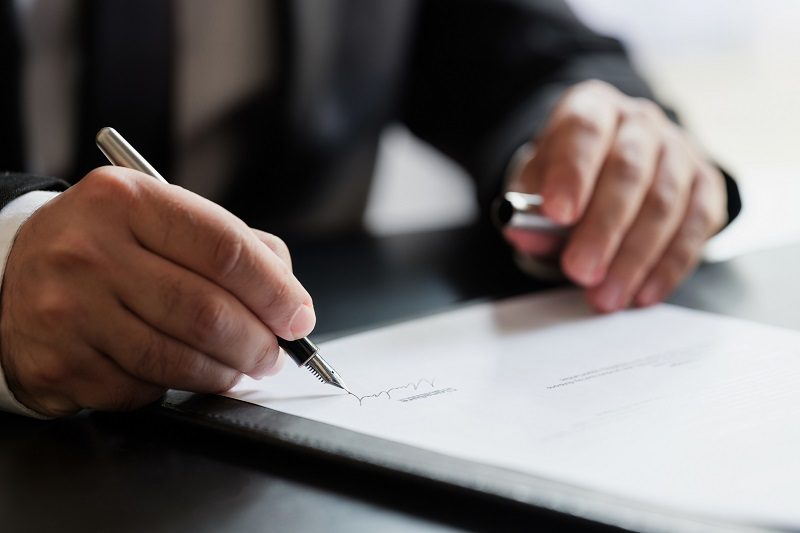 Businessman Signing Contract In The Office