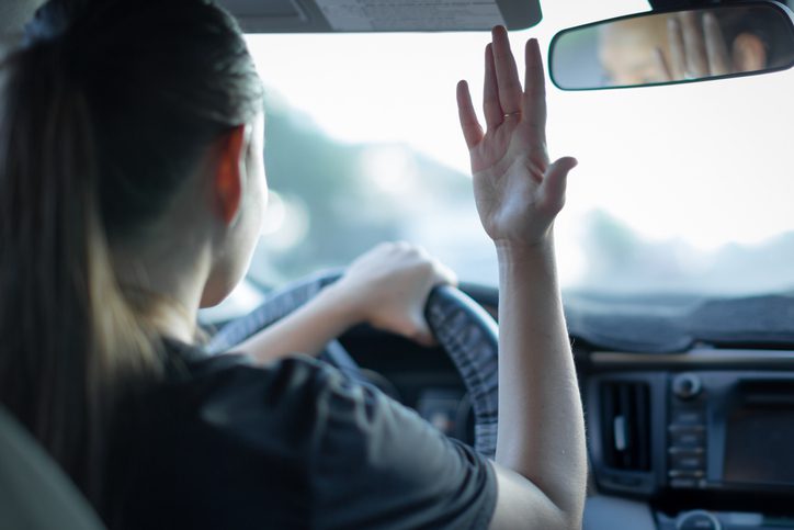 Woman in car expressing road rage