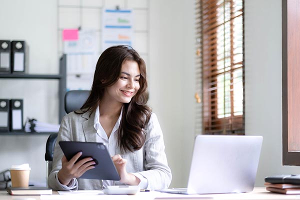 Woman doing taxes for her employees, putting group term life insurance on their W2s