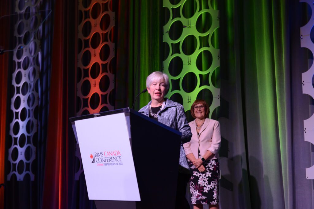 Catherine Dowdall, director of insurance and loss control at AECON Construction receiving the Donald M. Stuart Award on stage at the RIMS Canada Conference