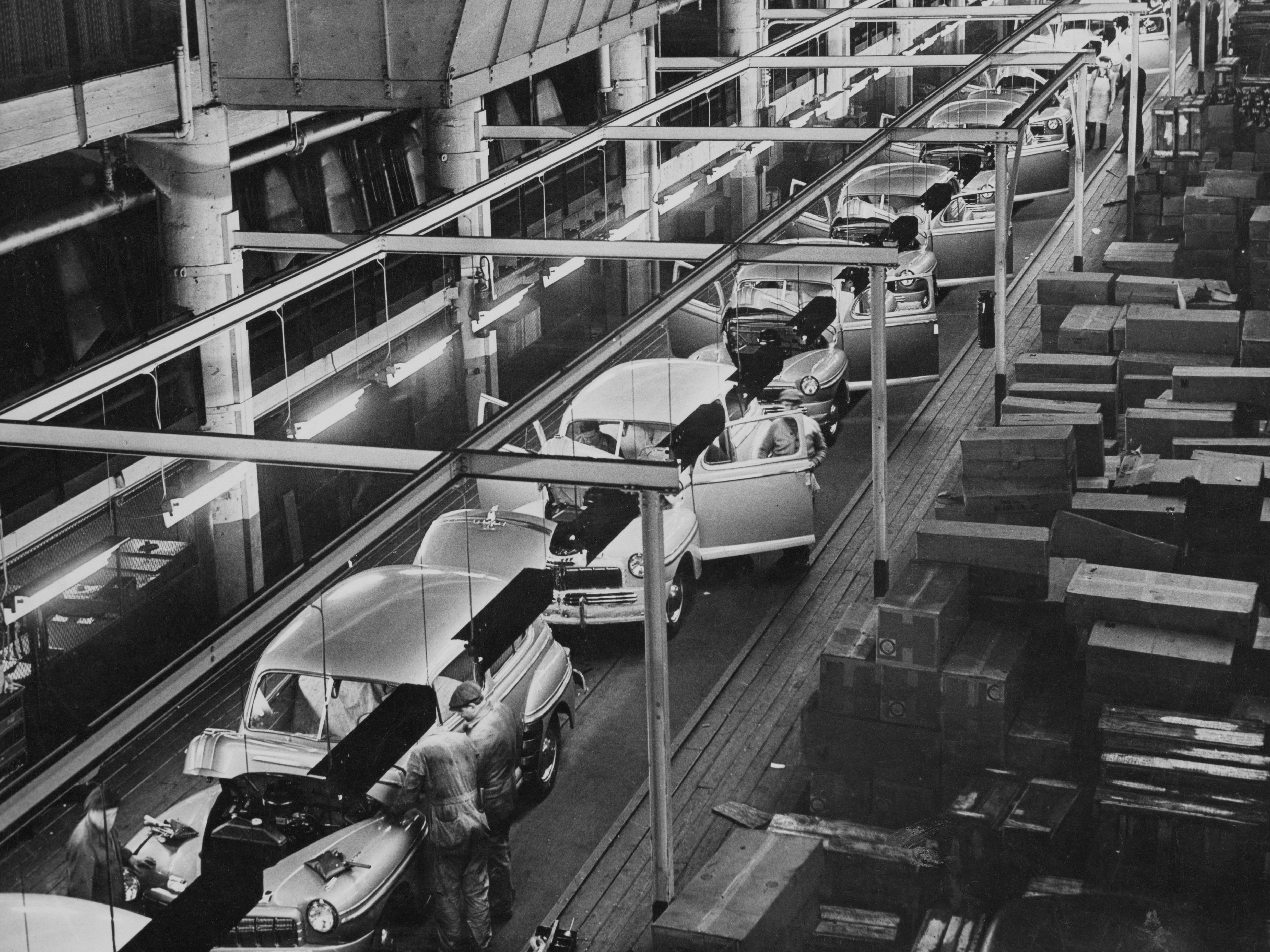 Automobile workers putting the finishing touches to 1947 models of the Mercury, one of three automobiles manufactured by the Ford Motor Company, at the company's River Rouge Complex in Dearborn, Michigan, 1947.