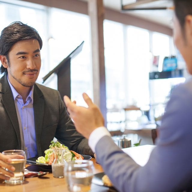 Businessmen having dinner together