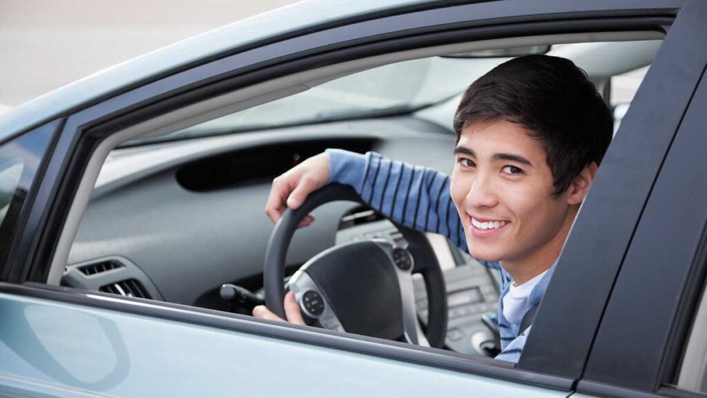 Cheap car insurance for new drivers - young man in new car