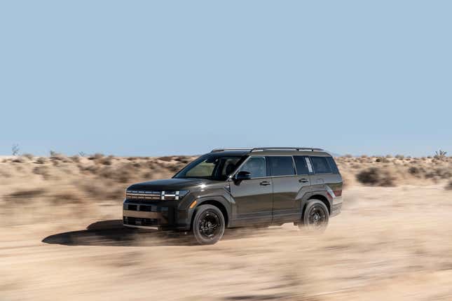 A new Hyundai Santa Fe driving through the desert.