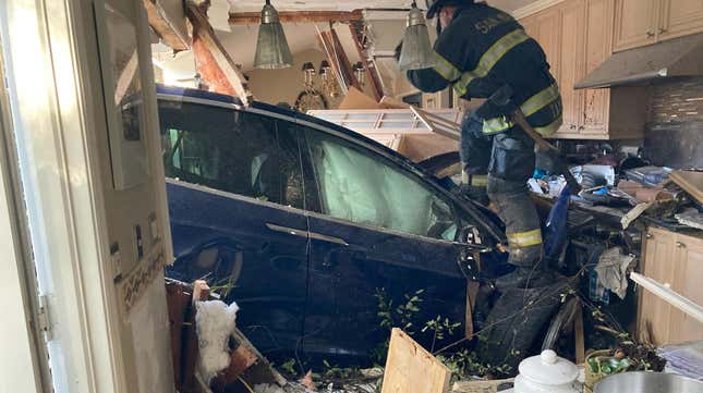 A blue Tesla Model X that crashed into a California house