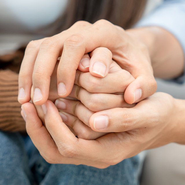 People hold hands supporting each other