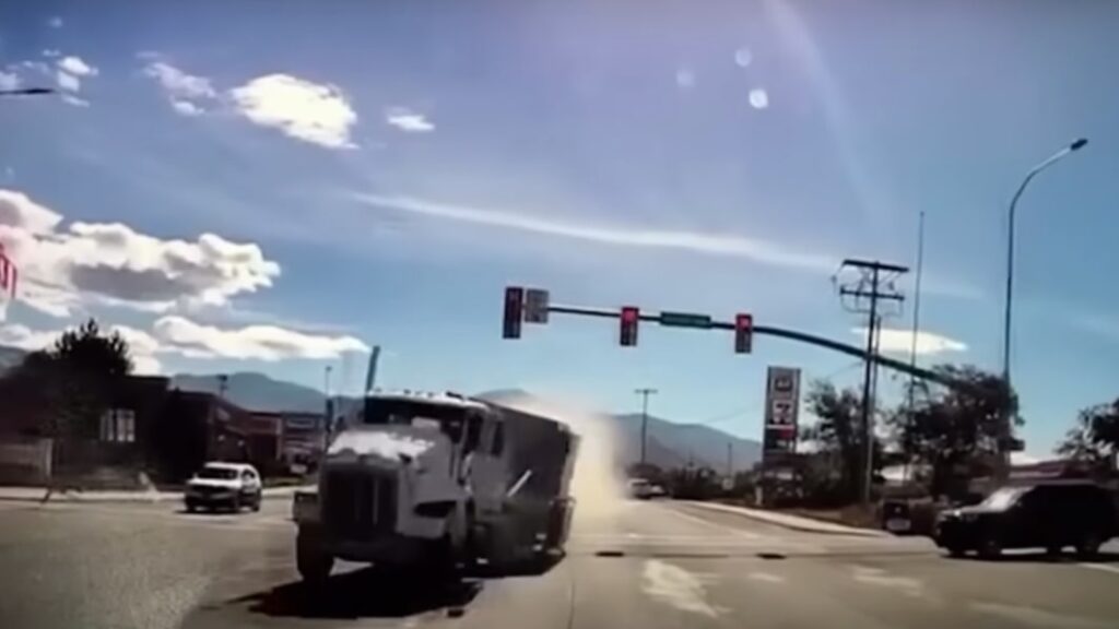 Runaway double-bottom semi takes out 33 cars as it barrels into dealership