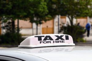 Taxi sign on top of car