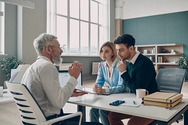 Financial advisor meeting with clients to talk about the benefits of an overfunded life insurance policy