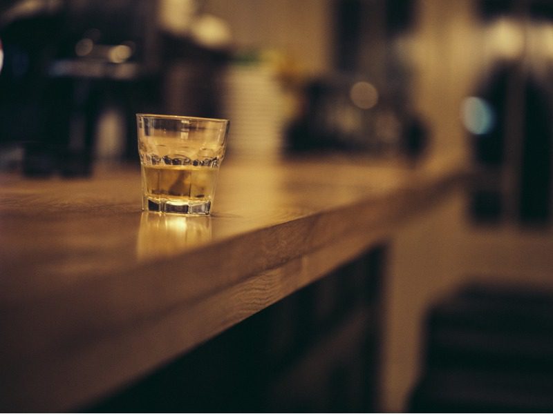 Glass of whiskey on a bar counter