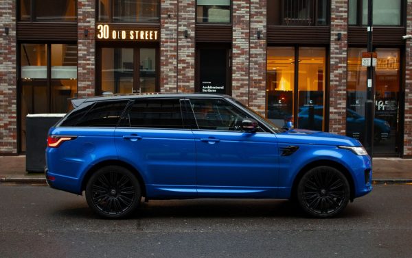 Blue Range Rover parked outside brown building