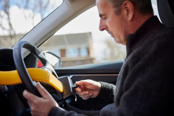 Man unlocking steering wheel lock