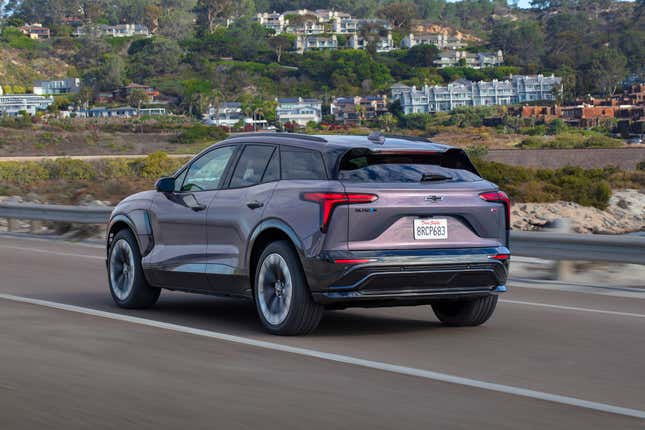 A purple-ish grey Blazer EV driving near the coast