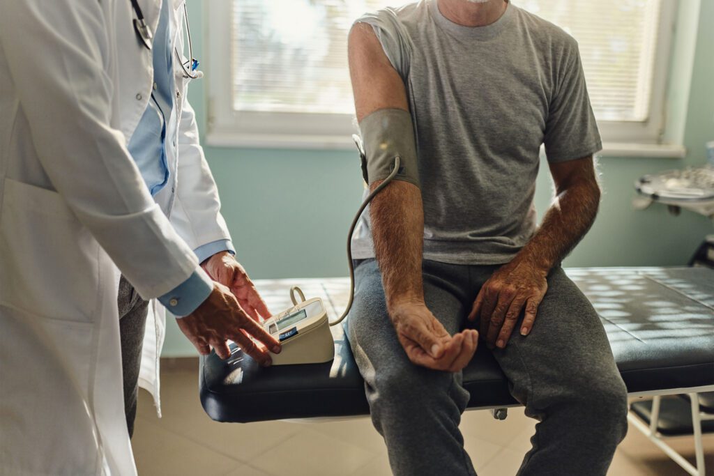 A photo of a doctor taking a patient's blood pressure.