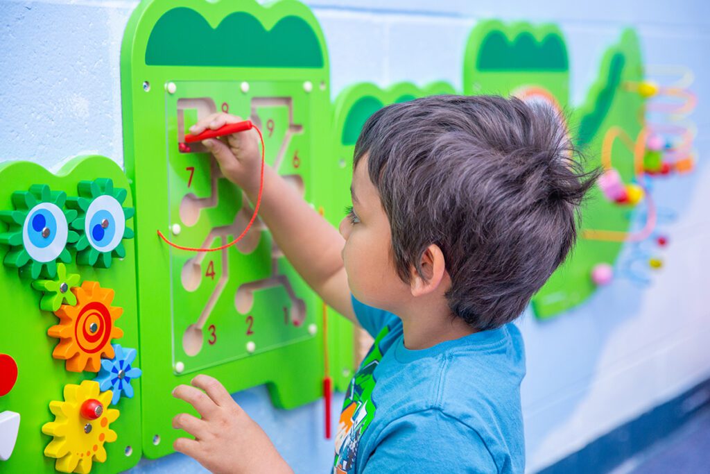 A child plays with a sensory toy.