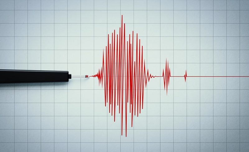 Seismograph Recording an Earthquake Activity on Grid Paper