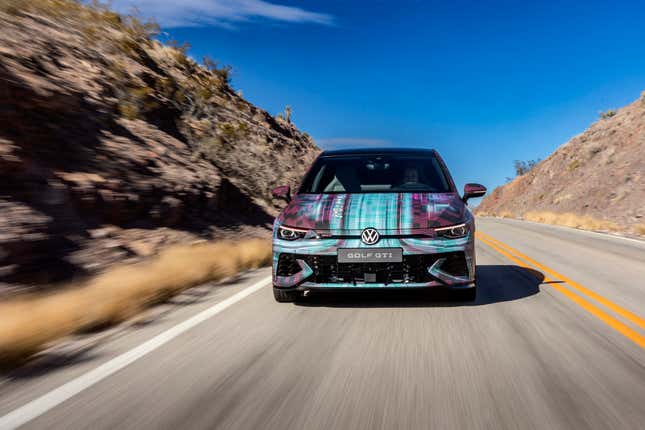 A head-on view of the camouflaged MK8.5 GTI driving through the desert.