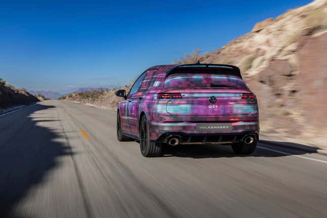 A rear-view of the MK8.5 GTI in camouflage driving through the desert.