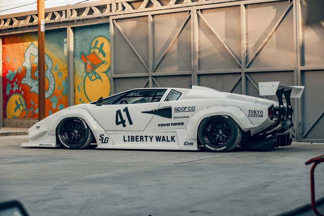 Side view of a white Lamborghini Countach with a Liberty Walk body kit