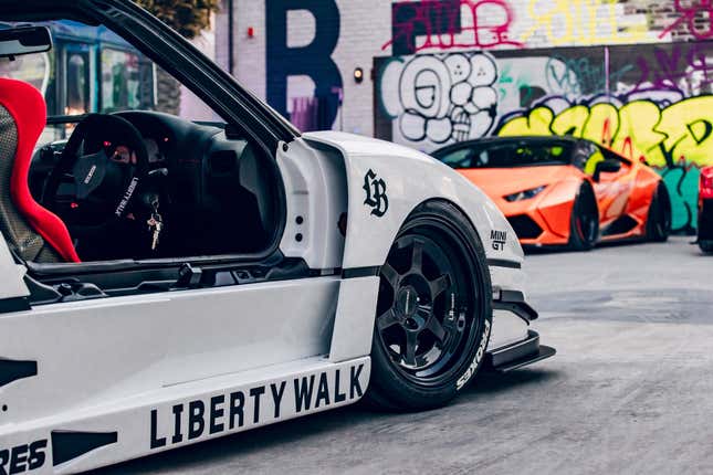 Wheel and front fender of a white Autozam AZ-1 with a Ferrari F40 bodykit