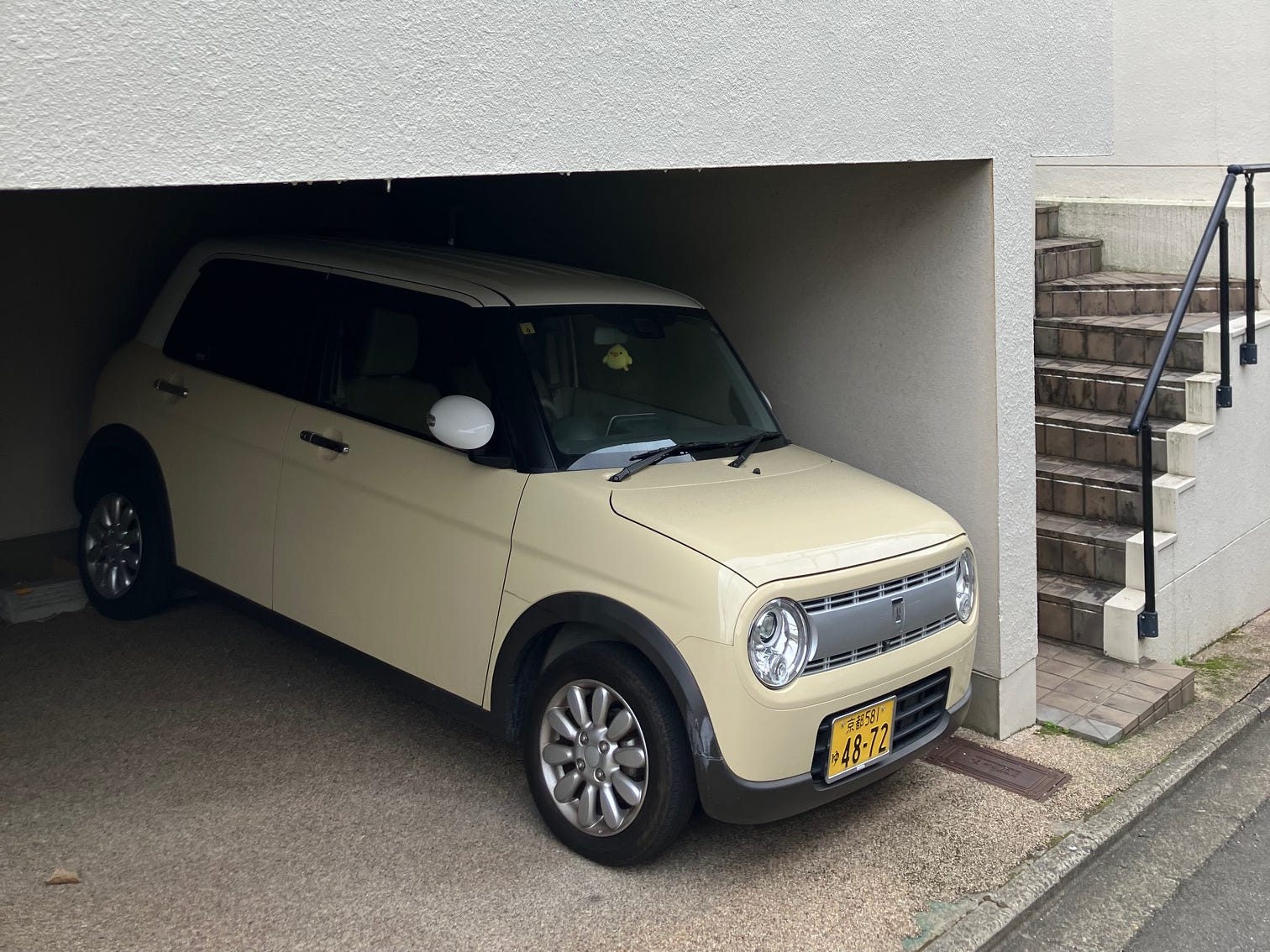 A Suzuki Alto Lapin parked in a garage in Kyoto