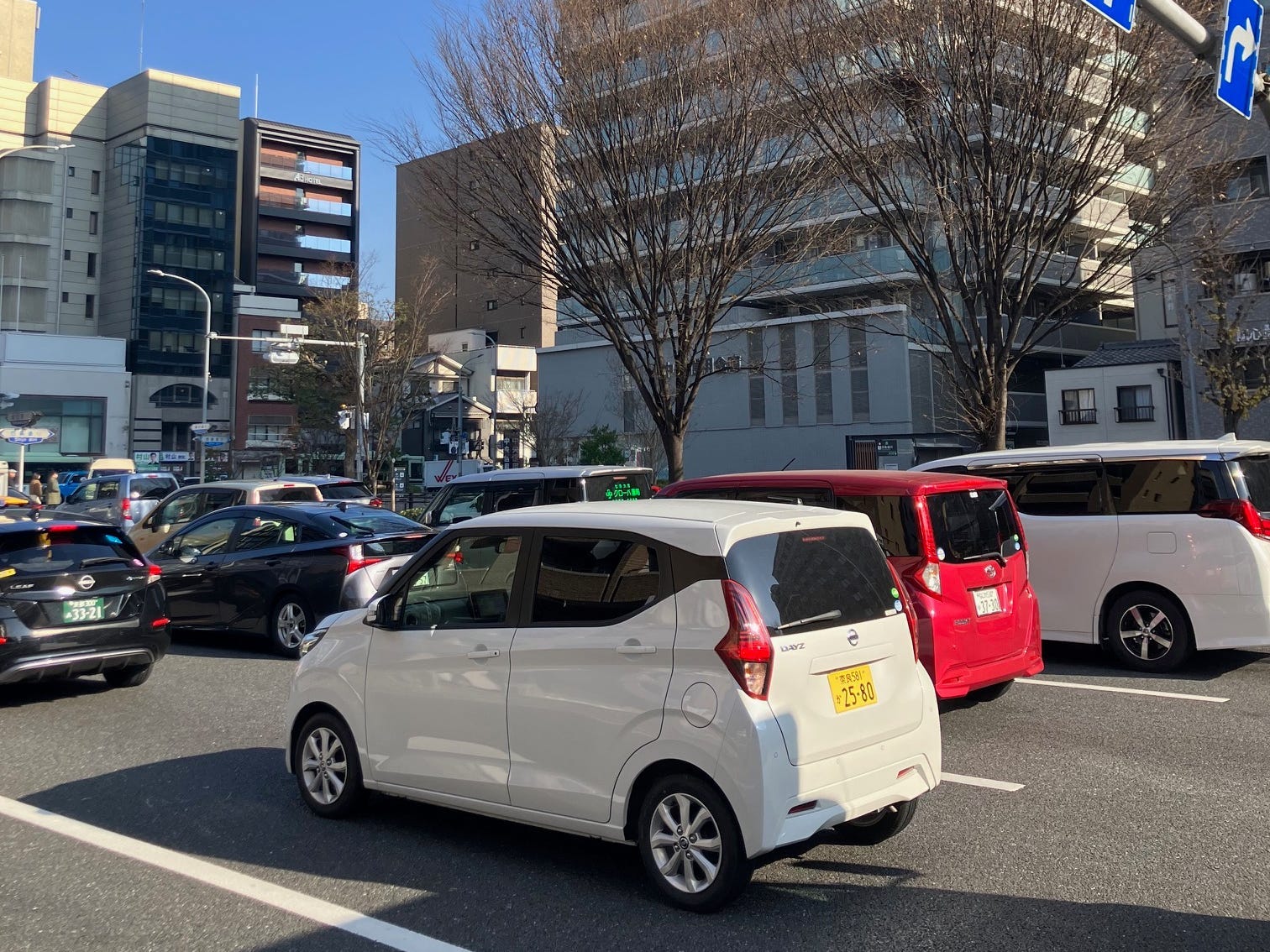 A Nissan Dayz kei car waits in traffic in Japan