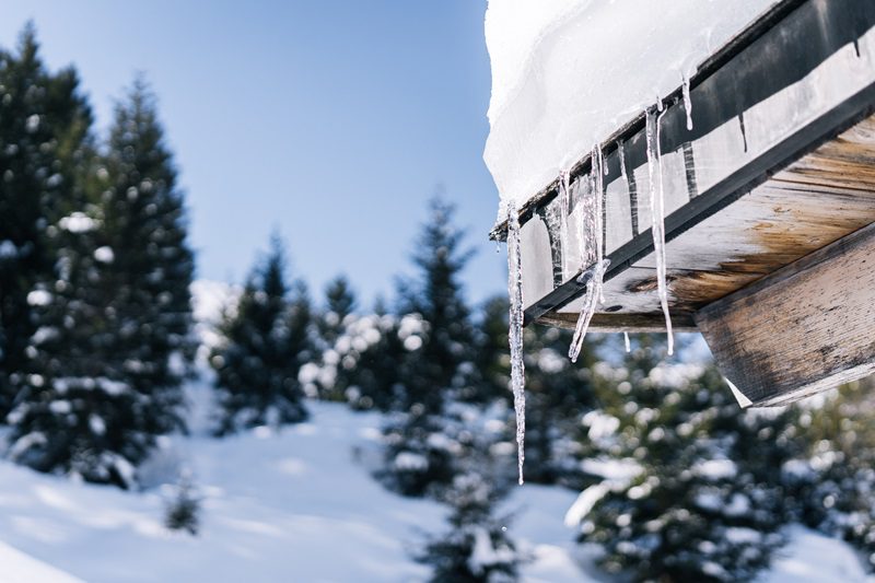 Icicle hangs from edge of building