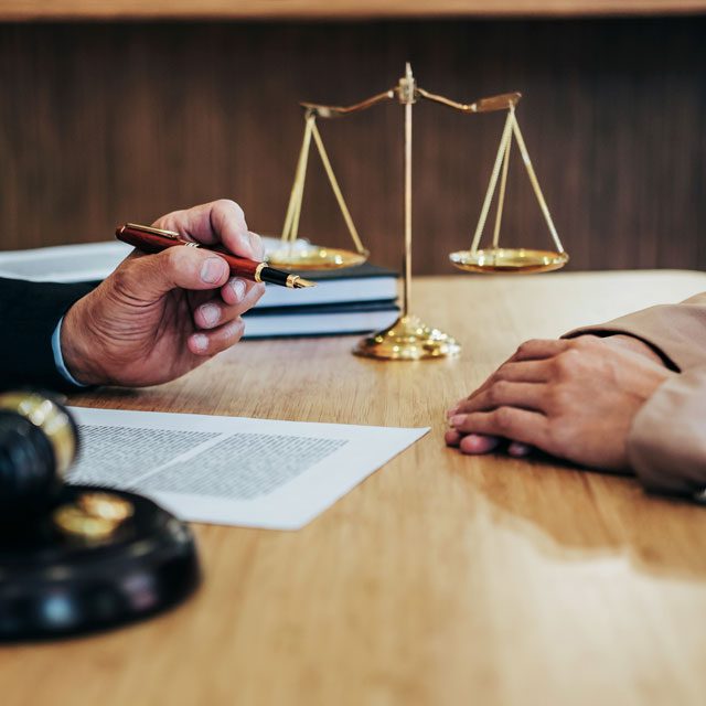 People working over legal papers in a law office