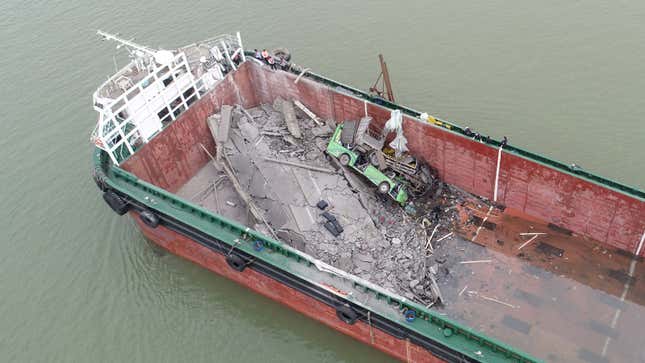 A photo of crumpled vehicles in a boat. 