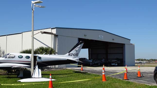 A photo of a plane crashed into a lampost at an airport.