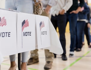 People waiting in line to vote at a United States polling station.