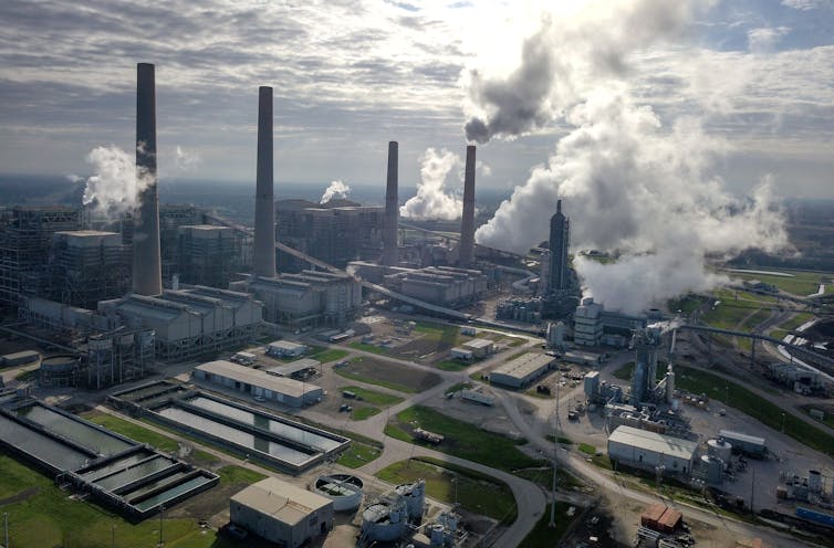 Aerial view of a large power plant with tall smokestacks