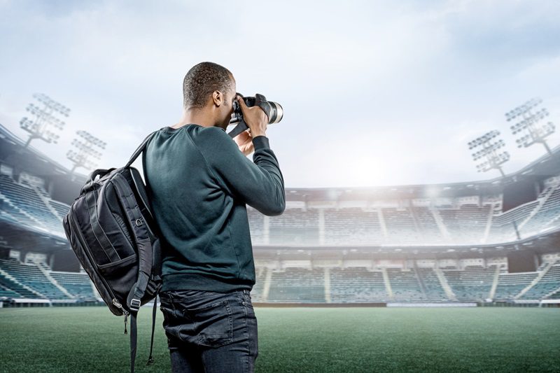 Sports Photographer in an empty stadium