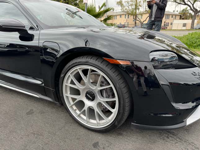 Front wheel of a black Porsche Taycan Cross Turismo