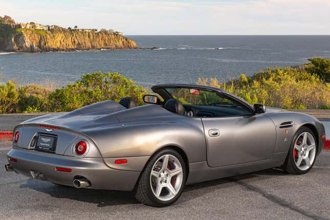 A rear 3/4 shot of the car in front of the ocean showing off the coachbuilt rear end