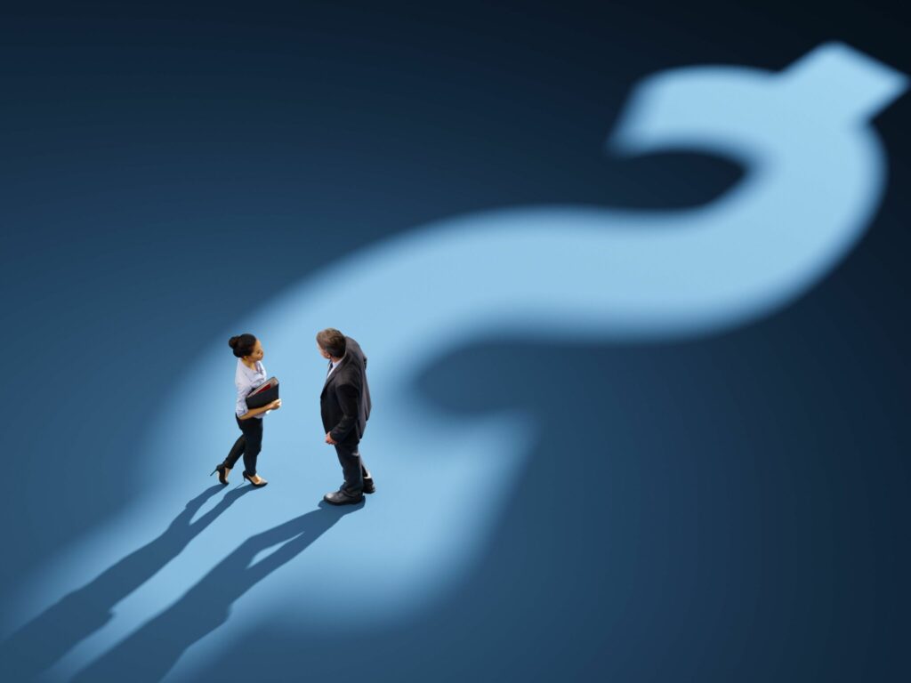 Business people standing on a shadow of a Canada dollar sign