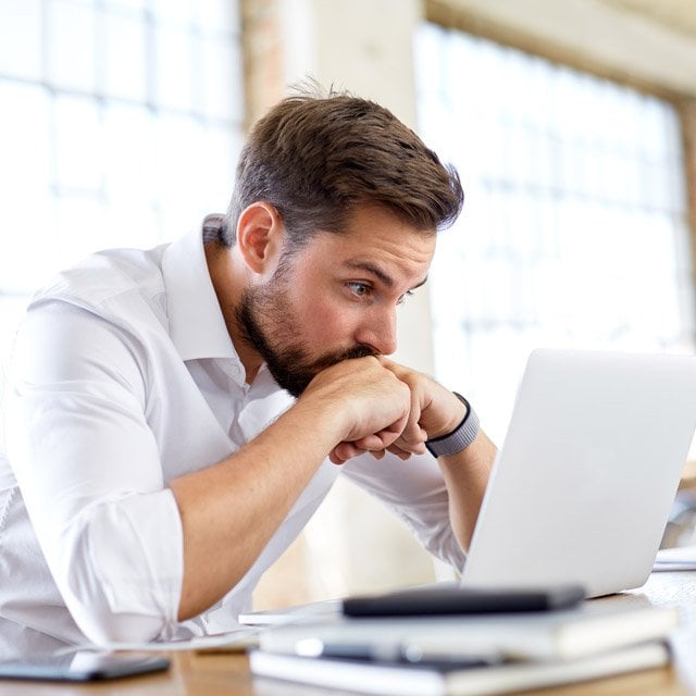 A worried businessman at a computer