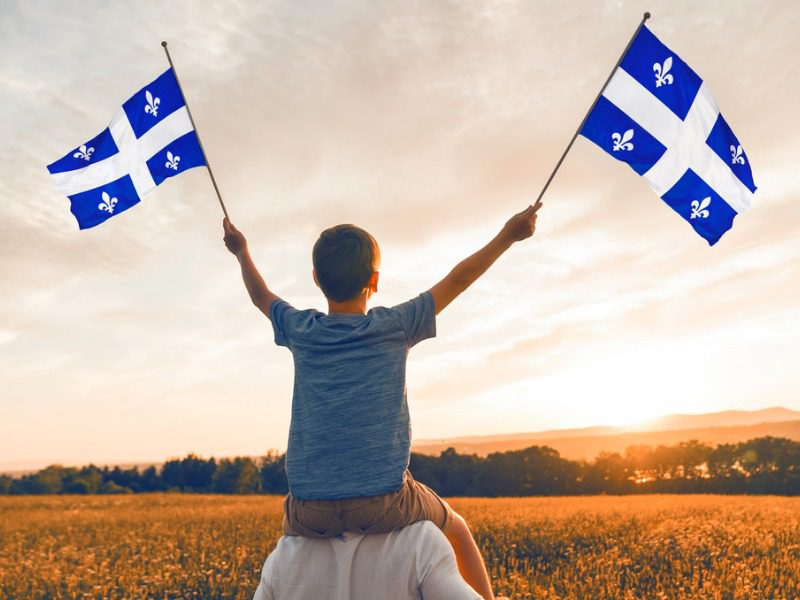 Child waving Quebec flags