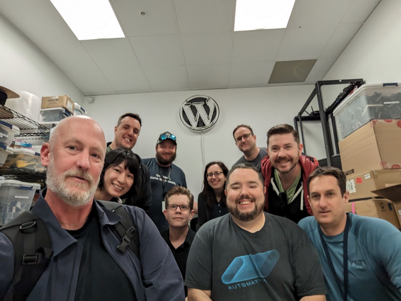 Group of Automattic employees taking a group picture at a data center. 