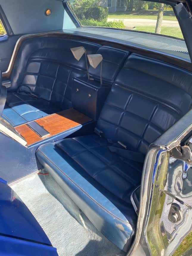 A photo of the Apollo back seat showing the reading lamps sticking up out of the center arm rest